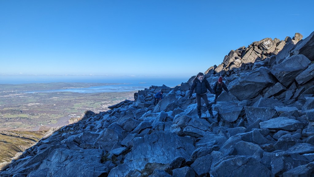 Scrambling up rocks to the summit of Carnedd y Filiast