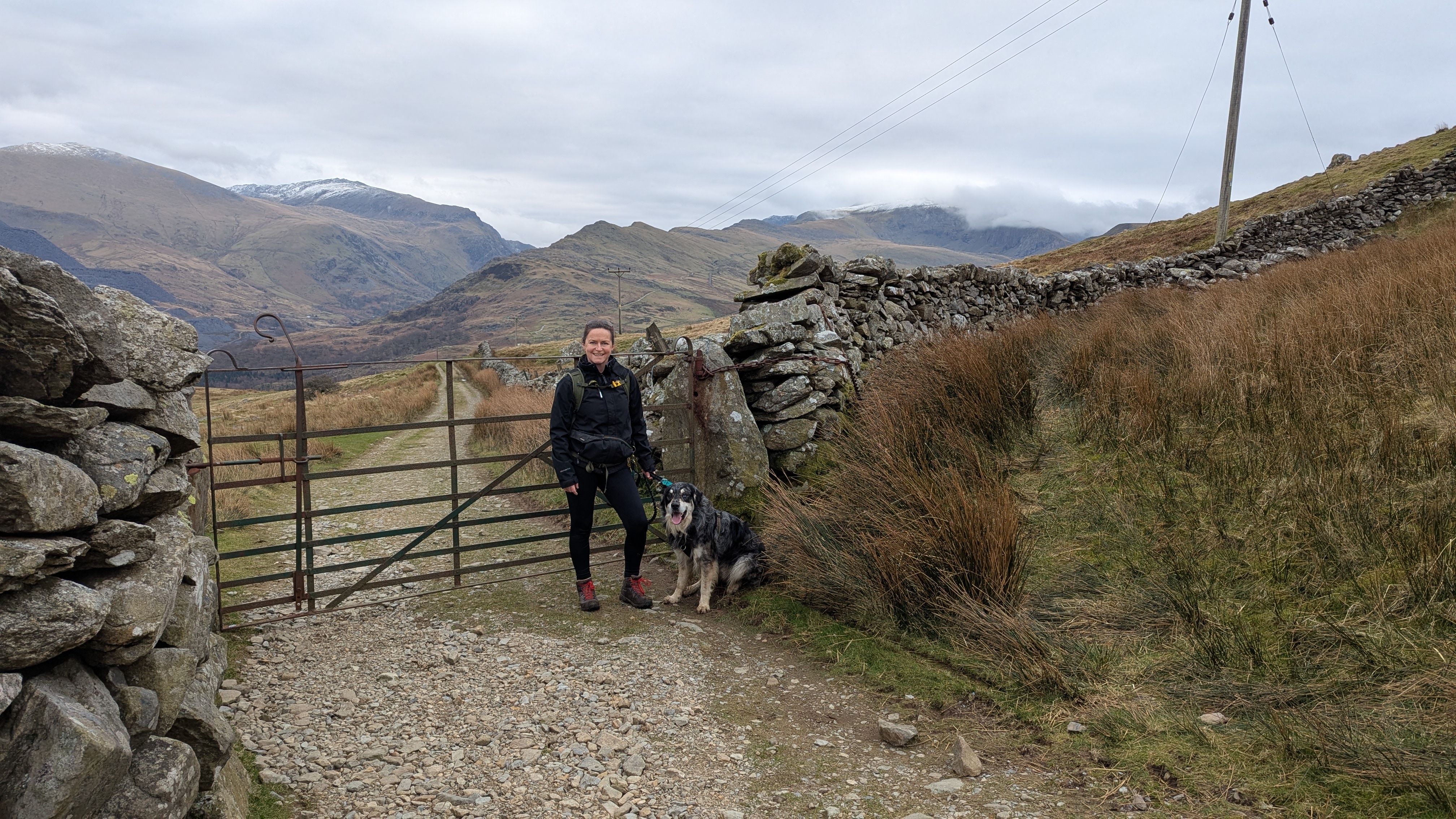 Hilary in front of a gate on the way up to Meol Eilio summit