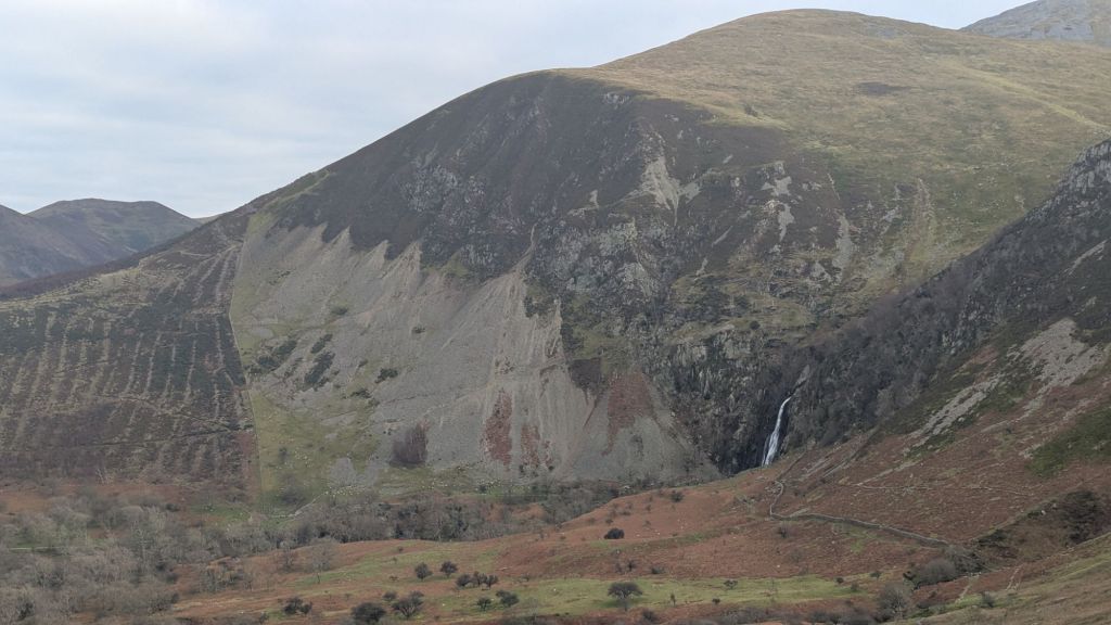 A scenic view of Bera Bach above Aber Falls, showcasing the mountainous terrain and cascading waterfall in the valley below.